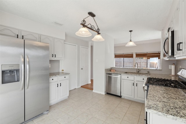 kitchen featuring decorative light fixtures, white cabinetry, appliances with stainless steel finishes, and tasteful backsplash