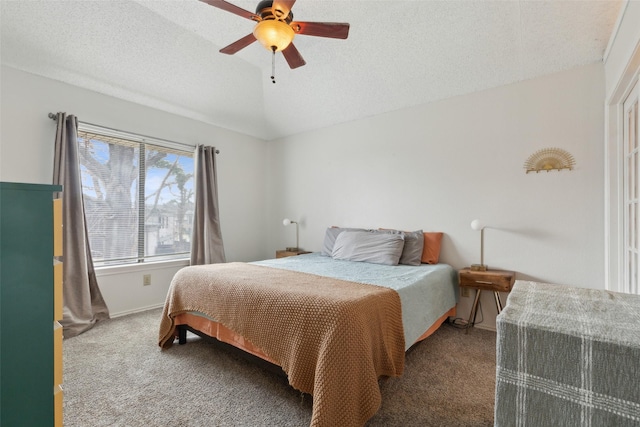 carpeted bedroom with a textured ceiling, vaulted ceiling, and ceiling fan