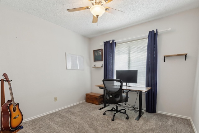 office area featuring a textured ceiling, ceiling fan, and light carpet