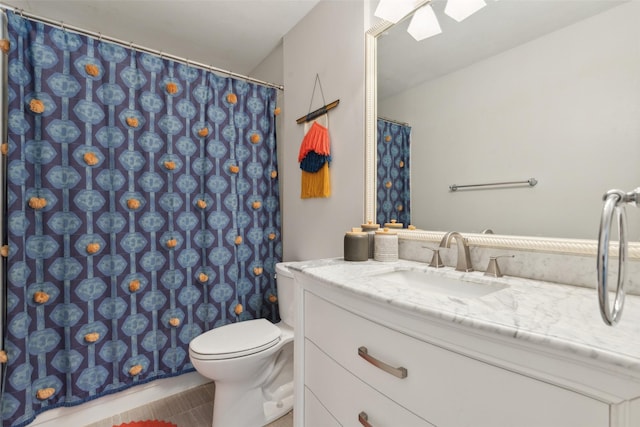 bathroom featuring tile patterned floors, vanity, and toilet