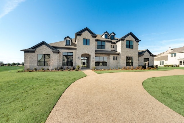 french country home featuring a front lawn