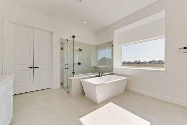 bathroom with tile patterned floors and separate shower and tub