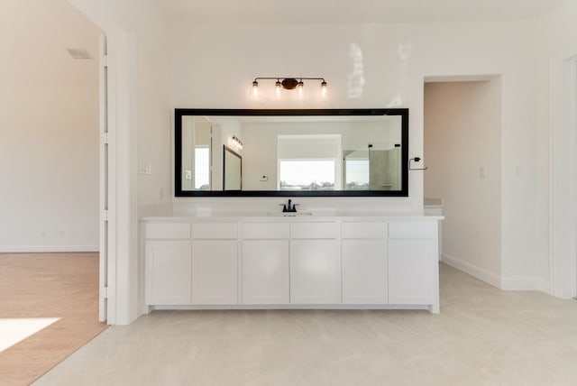 bathroom with tile patterned flooring and vanity