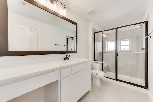 bathroom with tile patterned floors, vanity, an enclosed shower, and toilet