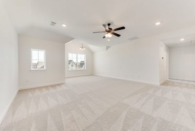 spare room with lofted ceiling, light colored carpet, and ceiling fan