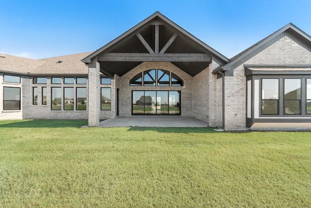 back of property featuring a patio and a lawn