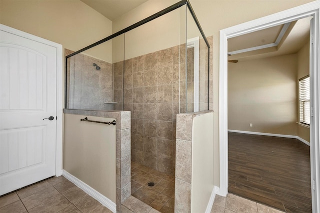 bathroom featuring a tile shower and tile patterned flooring