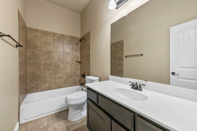 full bathroom with tile patterned flooring, vanity, tiled shower / bath combo, and toilet