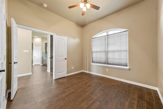 unfurnished room featuring ceiling fan, dark hardwood / wood-style flooring, and lofted ceiling