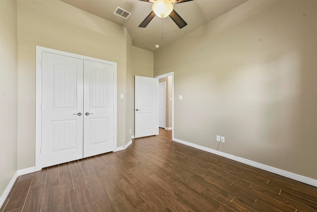 unfurnished bedroom with ceiling fan, a closet, and dark hardwood / wood-style floors