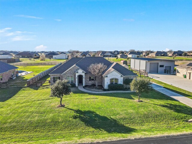 ranch-style home featuring a garage and a front lawn