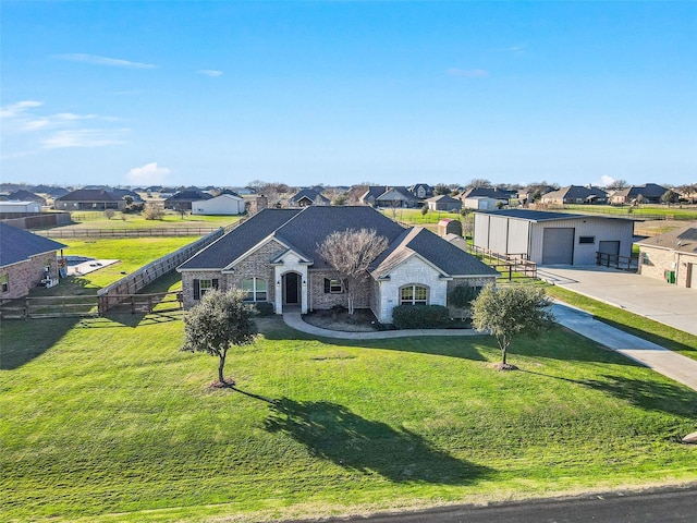 ranch-style home featuring a garage and a front lawn