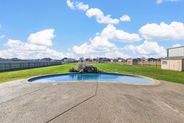 view of swimming pool with a storage shed, a yard, and a patio