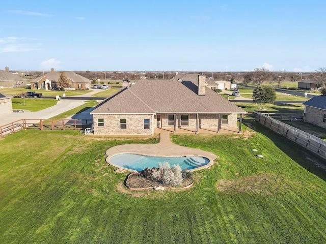 view of pool featuring a lawn and a patio area