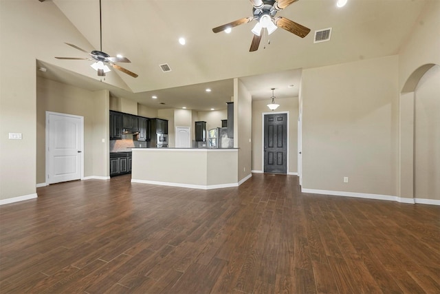 unfurnished living room with dark hardwood / wood-style flooring, high vaulted ceiling, and ceiling fan