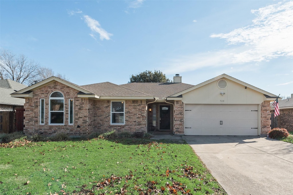 ranch-style home with a garage and a front lawn