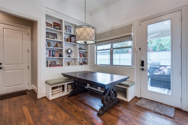 dining space featuring a healthy amount of sunlight, dark hardwood / wood-style flooring, and ornamental molding