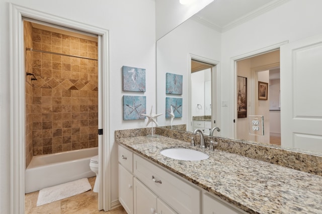 full bathroom featuring vanity, toilet, crown molding, and tiled shower / bath combo