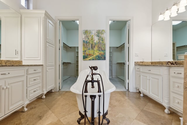 bathroom with a tub to relax in and vanity