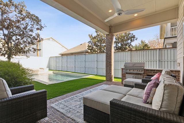 view of patio / terrace featuring area for grilling, an outdoor living space, ceiling fan, a fenced in pool, and a grill