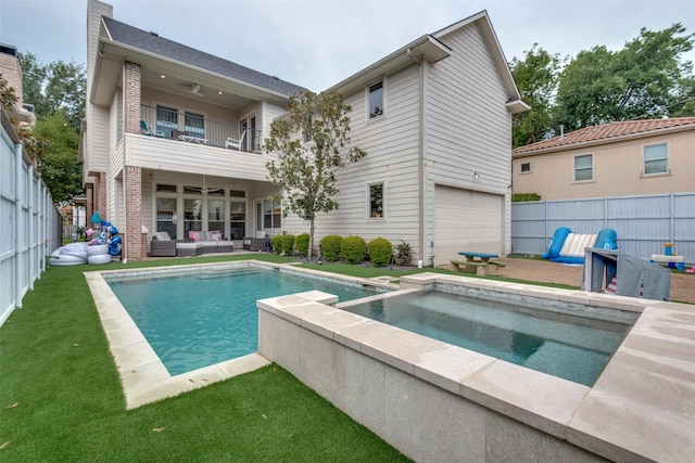 rear view of house with an outdoor hangout area, a balcony, and a pool with hot tub