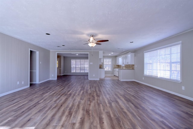 unfurnished living room featuring hardwood / wood-style flooring, a textured ceiling, and ceiling fan