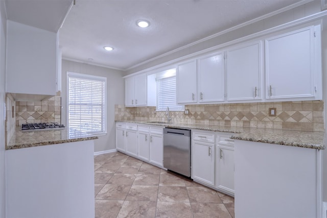 kitchen with sink, stainless steel appliances, light stone counters, tasteful backsplash, and white cabinets