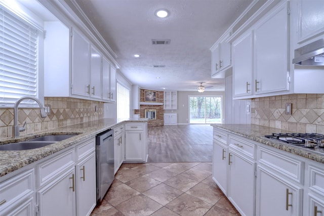 kitchen featuring sink, light stone counters, appliances with stainless steel finishes, ceiling fan, and white cabinets