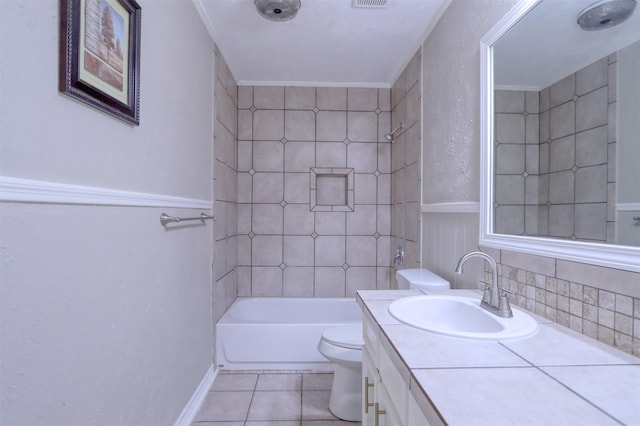 full bathroom featuring tile patterned floors, vanity, toilet, and tiled shower / bath combo