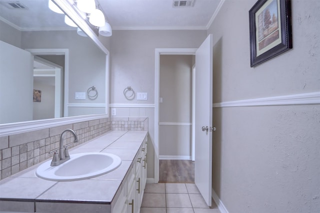 bathroom featuring tile patterned flooring, vanity, ornamental molding, and decorative backsplash