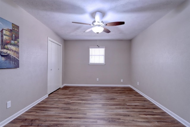 spare room with hardwood / wood-style floors and ceiling fan