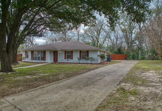 single story home featuring a front yard and cooling unit