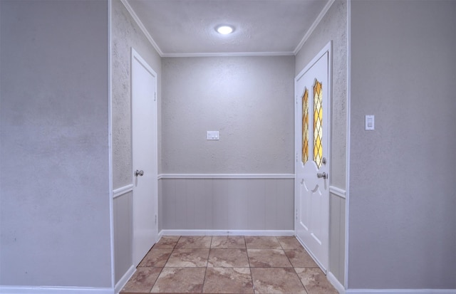 doorway featuring ornamental molding and light tile patterned floors