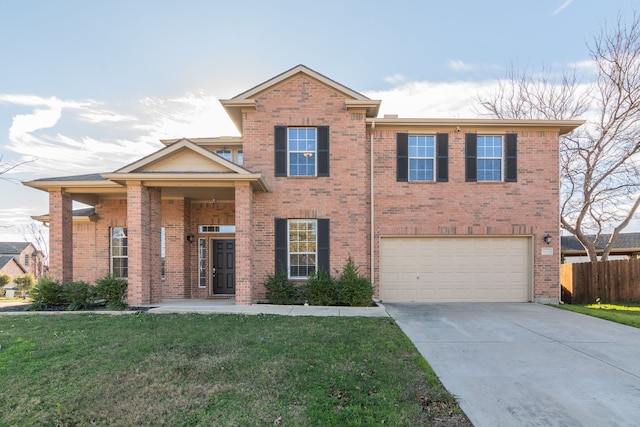 view of front of property with a garage and a front yard