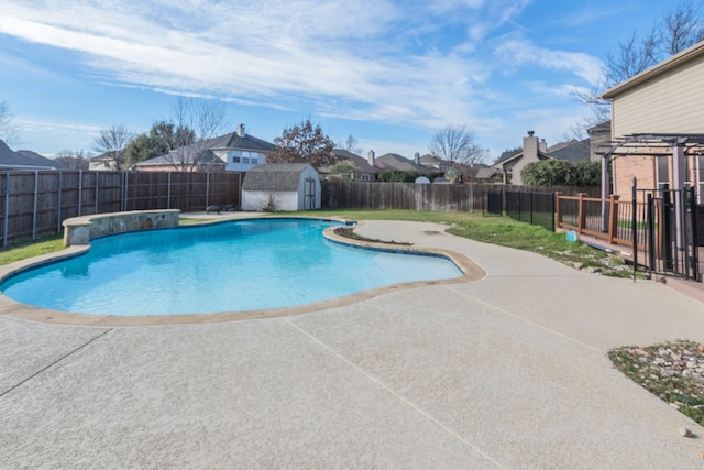 view of pool with a patio and a storage unit