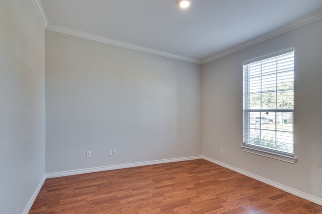 unfurnished room with ornamental molding and hardwood / wood-style flooring