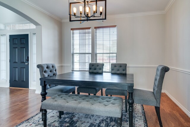 dining room featuring hardwood / wood-style flooring, a notable chandelier, and ornamental molding