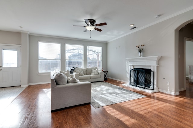 living room featuring crown molding, ceiling fan, and hardwood / wood-style flooring