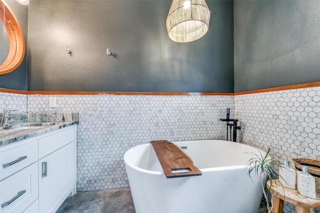 bathroom featuring a washtub and vanity