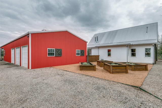 back of property featuring a garage