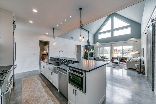 kitchen featuring high vaulted ceiling, sink, hanging light fixtures, white cabinetry, and stainless steel appliances