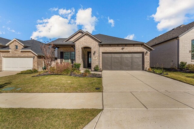 view of front of home with a garage and a front yard