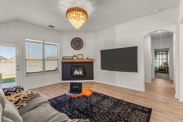 living room with lofted ceiling and light hardwood / wood-style floors