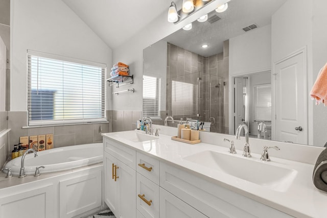 bathroom featuring lofted ceiling, shower with separate bathtub, and vanity