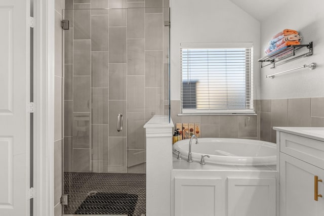 bathroom featuring vanity, separate shower and tub, and vaulted ceiling