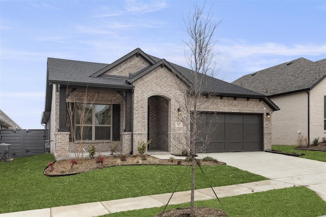 view of front of home with a garage and a front yard