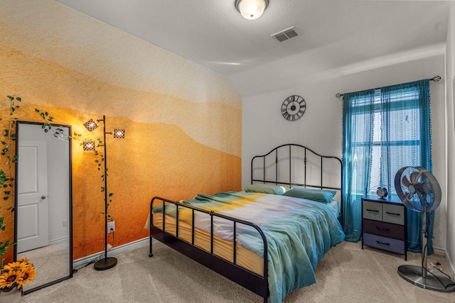 bedroom featuring a textured ceiling, carpet, and vaulted ceiling