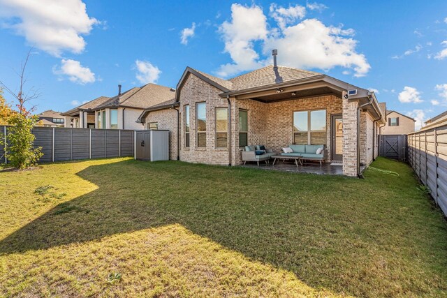 rear view of house with a lawn and an outdoor hangout area