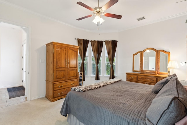 carpeted bedroom with ornamental molding and ceiling fan