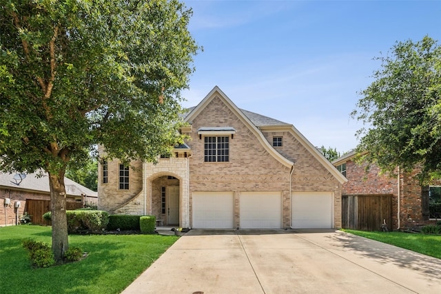 view of front of home with a garage and a front lawn